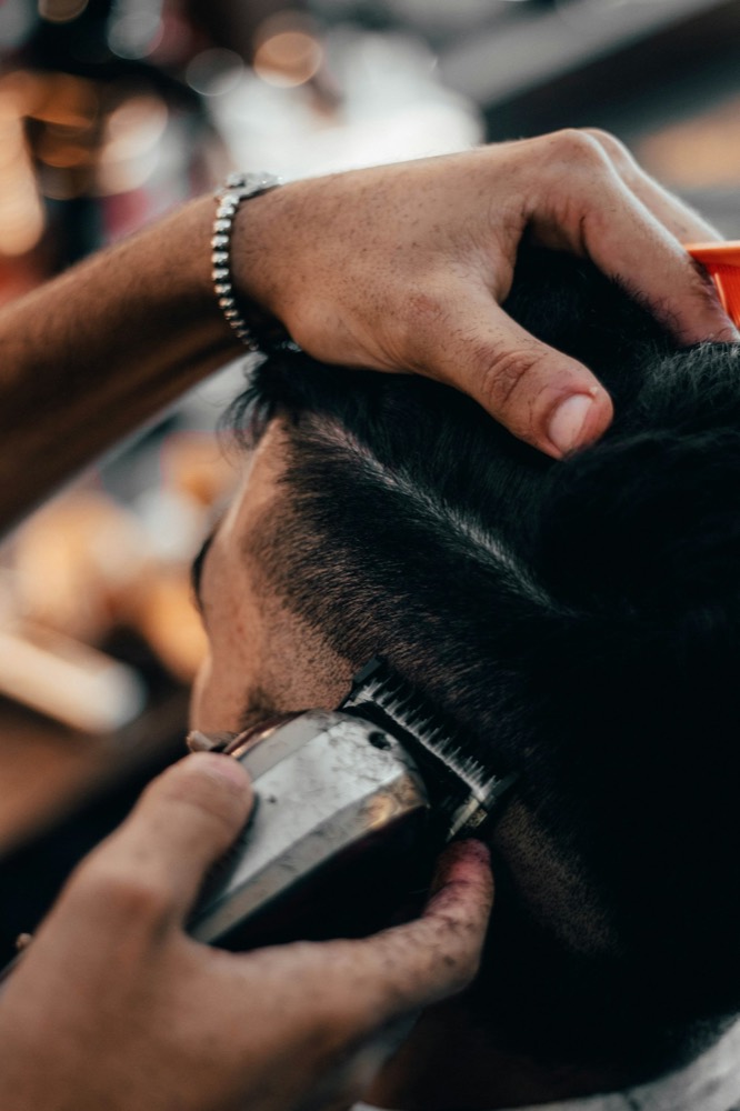 Close-up of clippers tapering a fresh fade