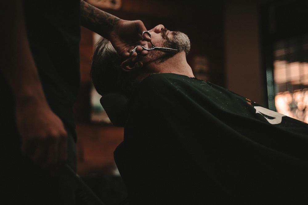 Client reclined in the chair for a straight razor shave